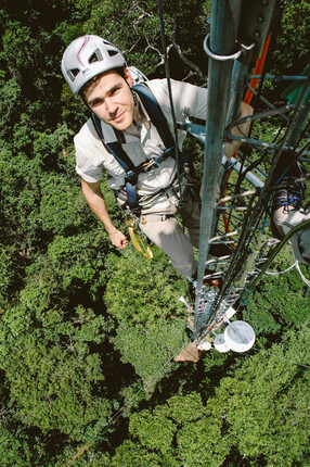 Man climbing a post 