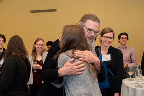 Luke Miratrix hugs student