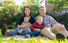 Blakely Bussie O'Connor with her husband and their two children sitting on grass