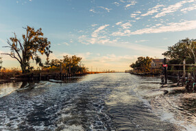 Sunset in the bayous beyond the retaining wall, New Orleans