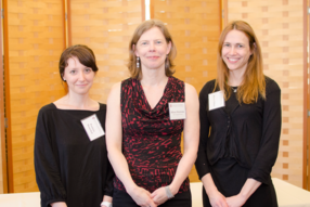 Three women smile at the camera