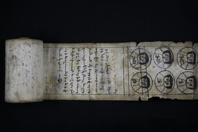 Partially unrolled scroll with handwritten text and illustrations.