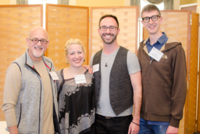 Four people smiling at the camera