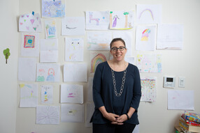 Kristina Olson in front of children's art