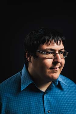 PhD student Noel Dominguez against black background