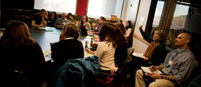 Students at table during conference.