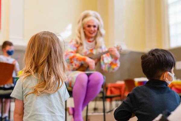 Children sit down for a performance during the Family Pride Event at Harvard Griffin GSAS, June 2022.
