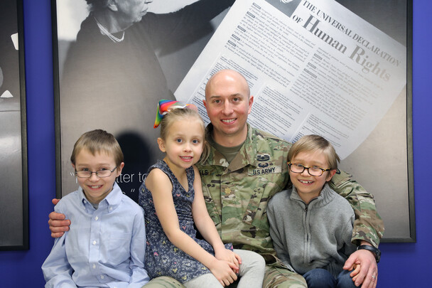 Sebastian Engels with in US Army fatigues surrounded by his three children