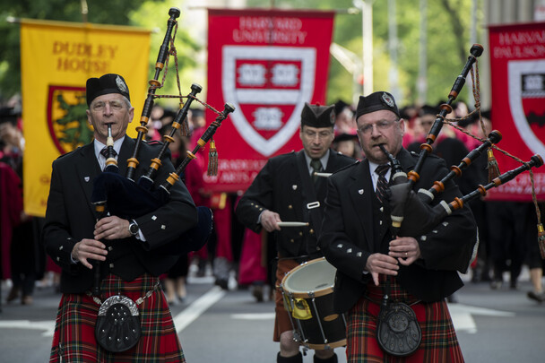 two men with bagpipes and one with a drum lead a parade