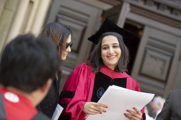 Smiling woman holds her diploma