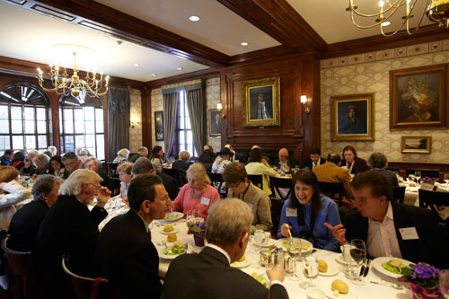 people enjoying a meal in the crowded dining room of Harvard's Faculty Club
