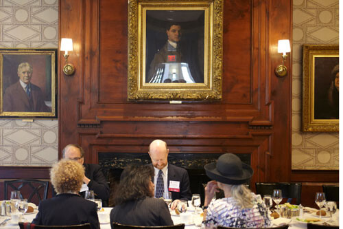 people at table underneath a portrait at Harvard's Faculty Club