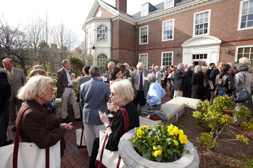crowd of older people gathered outside Harvard Faculty Club 